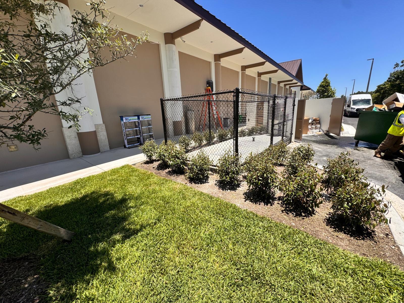 Commercial fence installation with landscaping